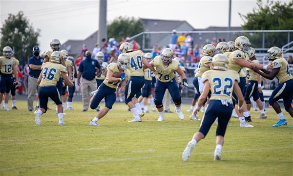 Independence High football team runs the ball